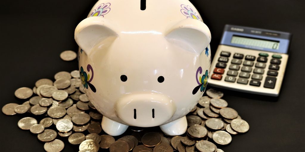 piggy bank with coins and financial planning documents